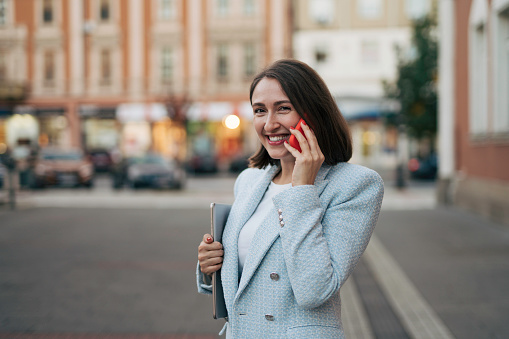 Young businesswoman or freelancer on a break talking on a phone