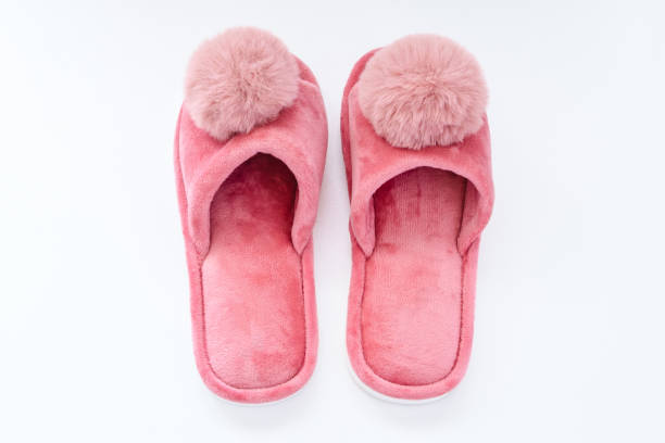 istock Pink home fluffy slippers on white background 1754745099