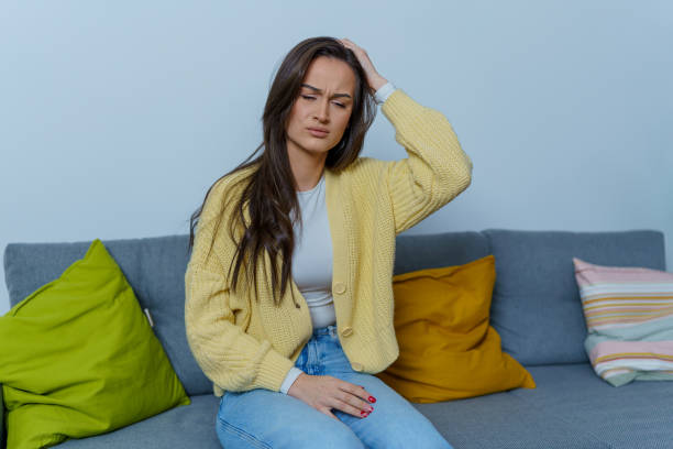 istock Young woman barely manages a strong headache at home 1754746571