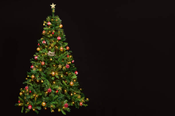 istock Beautifully decorated and illuminated Christmas tree on a black background 1754752253