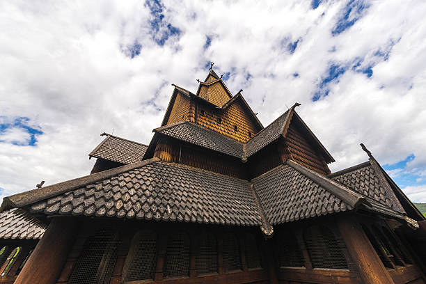 Stave Church in the Sky Dramatic sky above the stave church of Heddal in Norway. heddal stock pictures, royalty-free photos & images