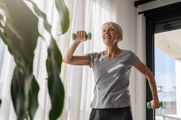istock Elderly smiling beautiful woman have training with dumbbells 1754759412