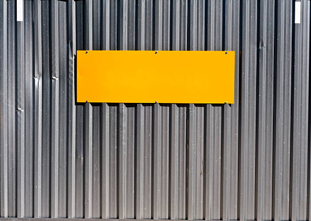 Orange plate on steel gate stock photo