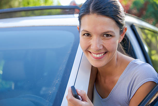 istock young woman leans against her car 175476604