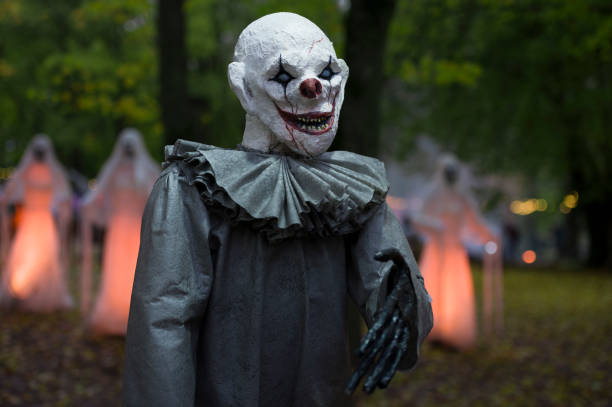 istock Halloween decoration, grinning clown standing on ghosts background in the forest 1754773891