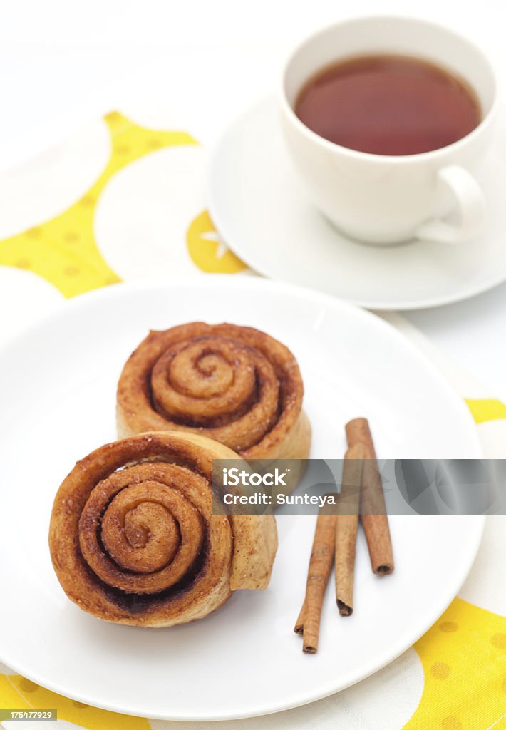 Homemade cinnamon rolls Homemade cinnamon rolls, cup of tea on blue serviette Baked Stock Photo