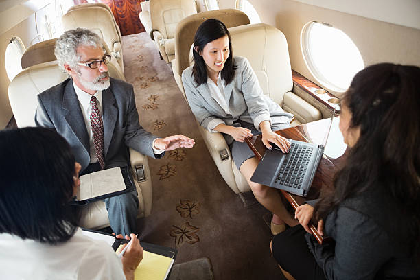 istock Diverse colleagues working whle travelling on company jet 175478073