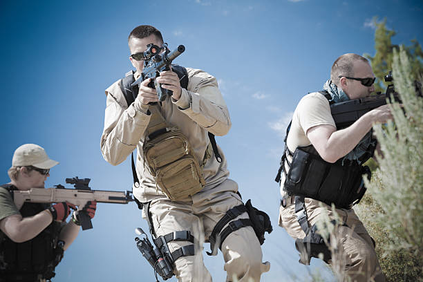 istock Platoon of military soldiers using weapons during training exercise 175478085