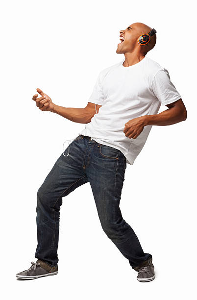 Man Enjoying Music - Isolated Full length of an ecstatic African American man playing air guitar while listening music on headphones. Vertical shot. Isolated on white. air guitar stock pictures, royalty-free photos & images