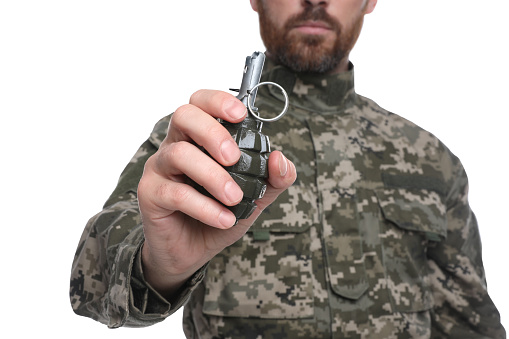 Soldier holding hand grenade on white background, closeup. Military service