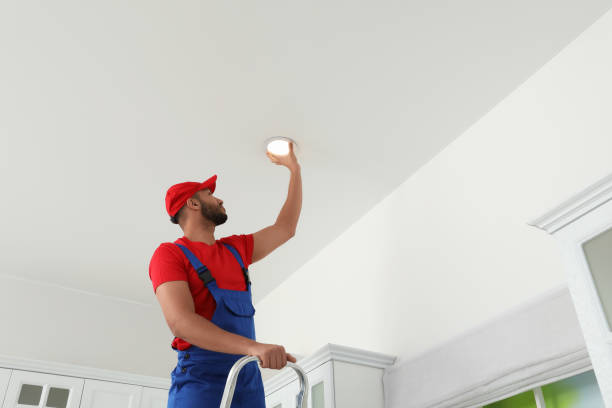 istock Electrician repairing ceiling lamp indoors, low angle view. Space for text 1754784457
