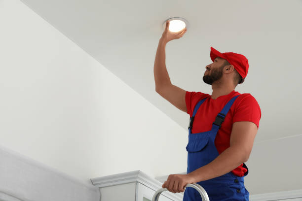istock Electrician repairing ceiling lamp indoors, low angle view. Space for text 1754784472