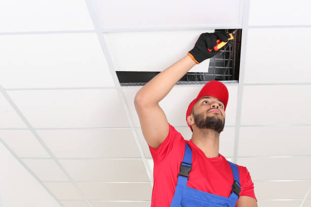istock Electrician with pliers repairing ceiling light indoors, low angle view. Space for text 1754784499