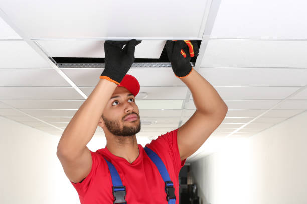 istock Electrician with pliers repairing ceiling light indoors, space for text 1754784500