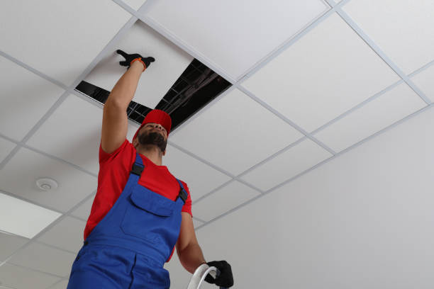 istock Electrician repairing ceiling light indoors, low angle view. Space for text 1754784889