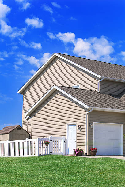 istock New home construction with a picket fence and clear blue sky 175479383