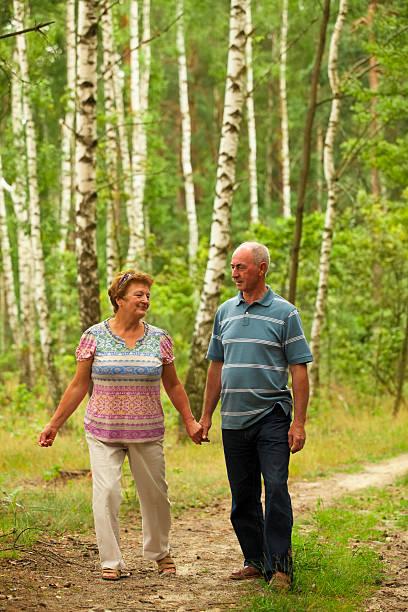 istock Senior couple walking in woods 175479776