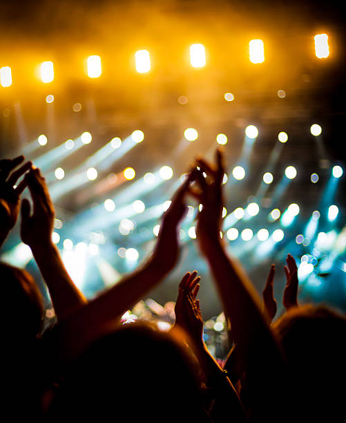 istock Peoples hands clapping above their head at concert 175479812