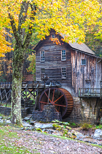 Autumn leaves set as the background of Glade Grist Mill, located at Babcock State Park in West Virginia