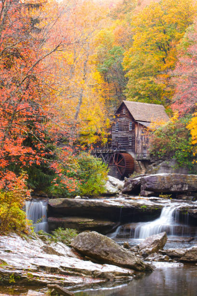 Autumn leaves set as the background of Glade Grist Mill, located at Babcock State Park in West Virginia