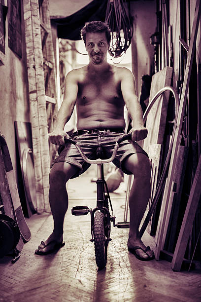 istock Adult man riding tiny bicycle 175479950