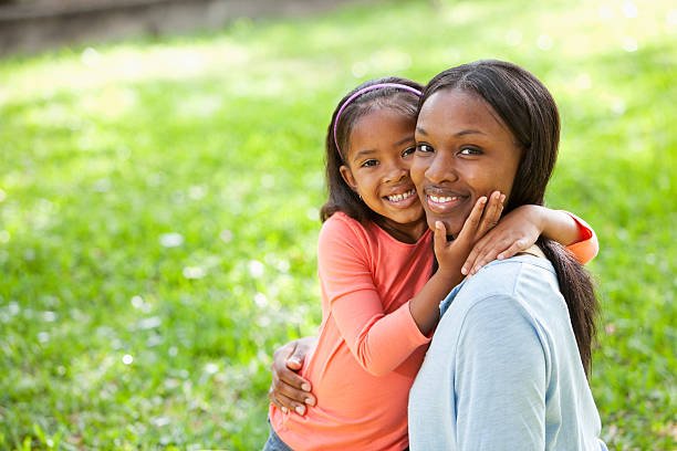 istock African American mother and daughter hugging 175480067