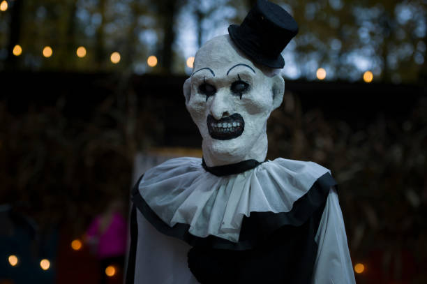istock Halloween decoration, grinning clown standing on ghosts background in the forest 1754802755