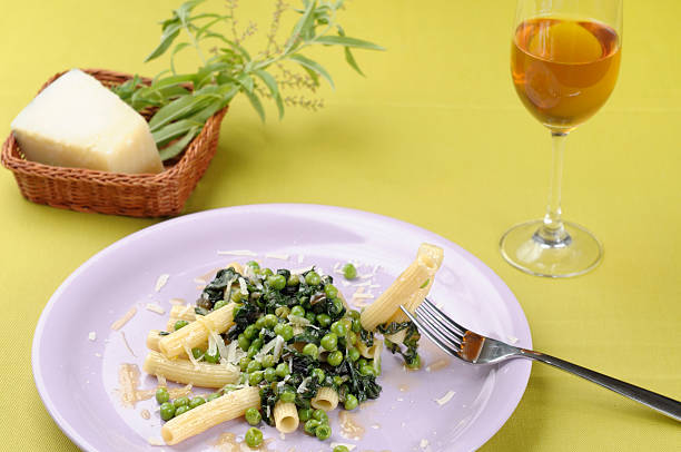 Sedani pasta with peas, lettuce and pecorino cheese "Sedani pasta with peas, lettuce and pecorino cheeseItalian cuisine" pecorino romano stock pictures, royalty-free photos & images