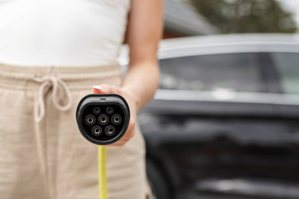 istock Electric car charging at home, EV car with plugged charger 1754812335