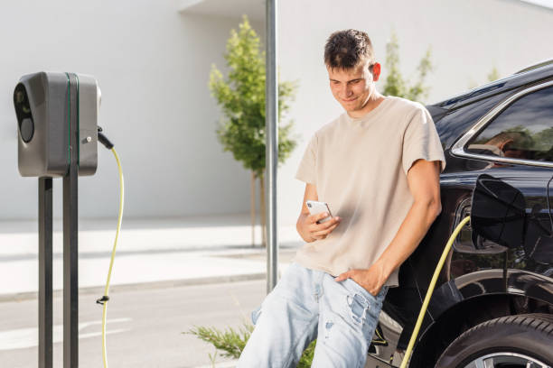 istock Man charging electric car in city 1754812984