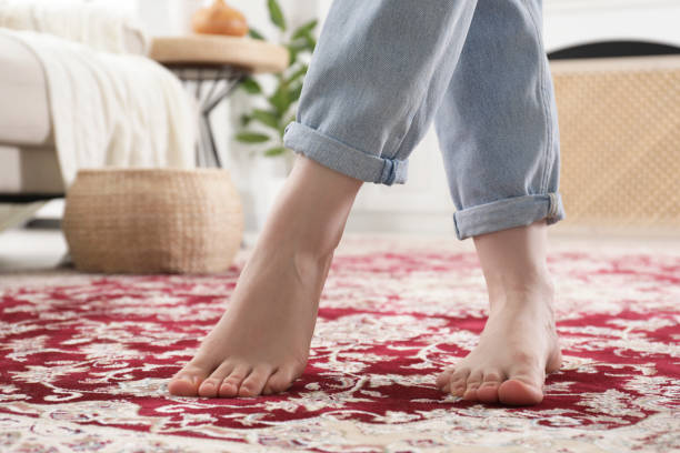 istock Woman standing on carpet with pattern at home, closeup 1754820020