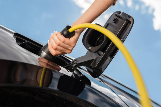 istock Female hand charging electric car 1754820575
