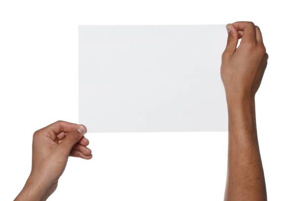 istock Man holding sheet of paper on white background, closeup. Mockup for design 1754820587