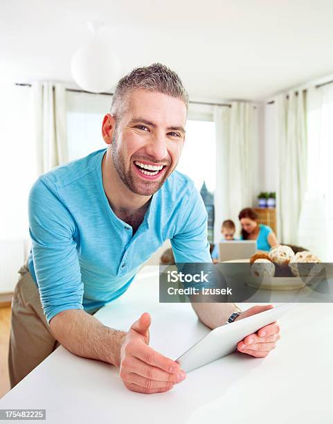 Happy Man With Tablet At Home Stock Photo - Download Image Now - Family, Home Interior, Laptop