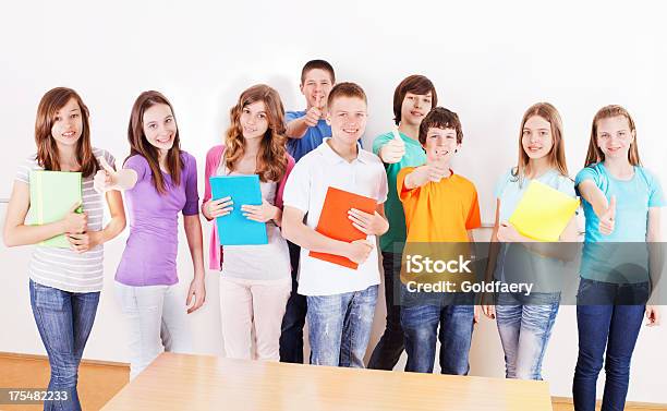 A Group Of Cheerful Preteen Students With Folders Smiling Stock Photo - Download Image Now