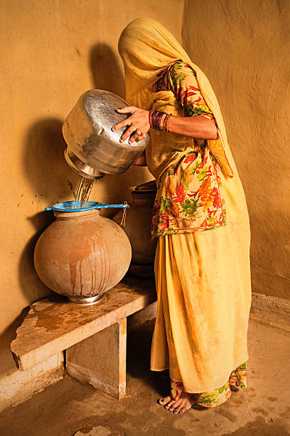 istock Indian woman carrying water from well. 175482296