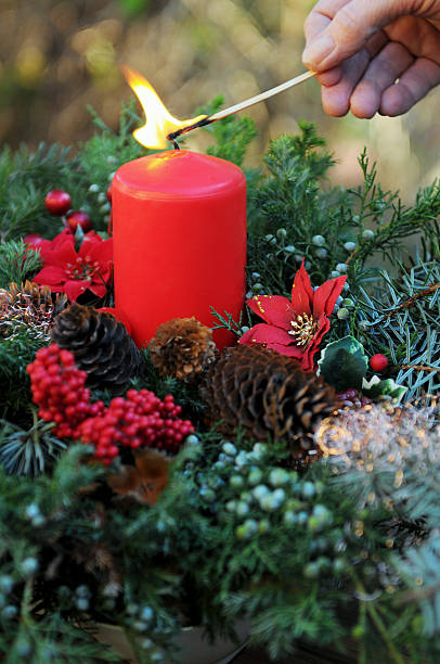 istock fire on Advent wreath with red candle and ornaments 175483508