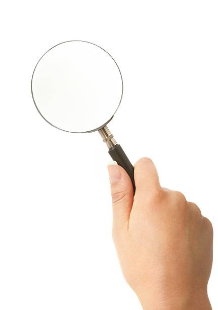 女性の手を押して拡大鏡白背景 - low scale magnification glass women holding ストックフォトと画像