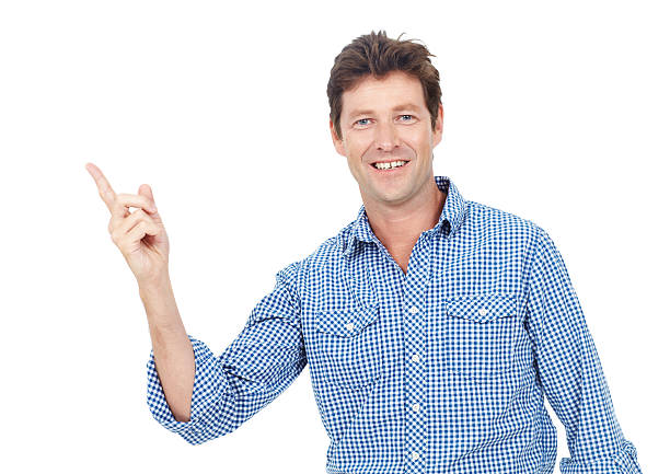 Male adult pointing to copyspace while smiling- portrait