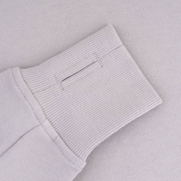 istock Sleeve cuff of a light gray sweatshirt with a hole for a finger 1754841786