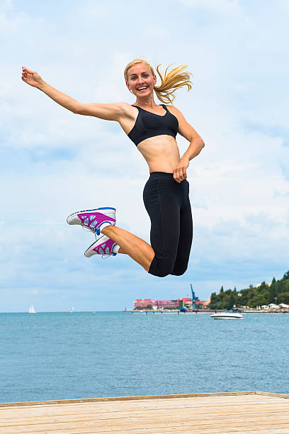 istock Attractive girl jumping by the sea 175484312