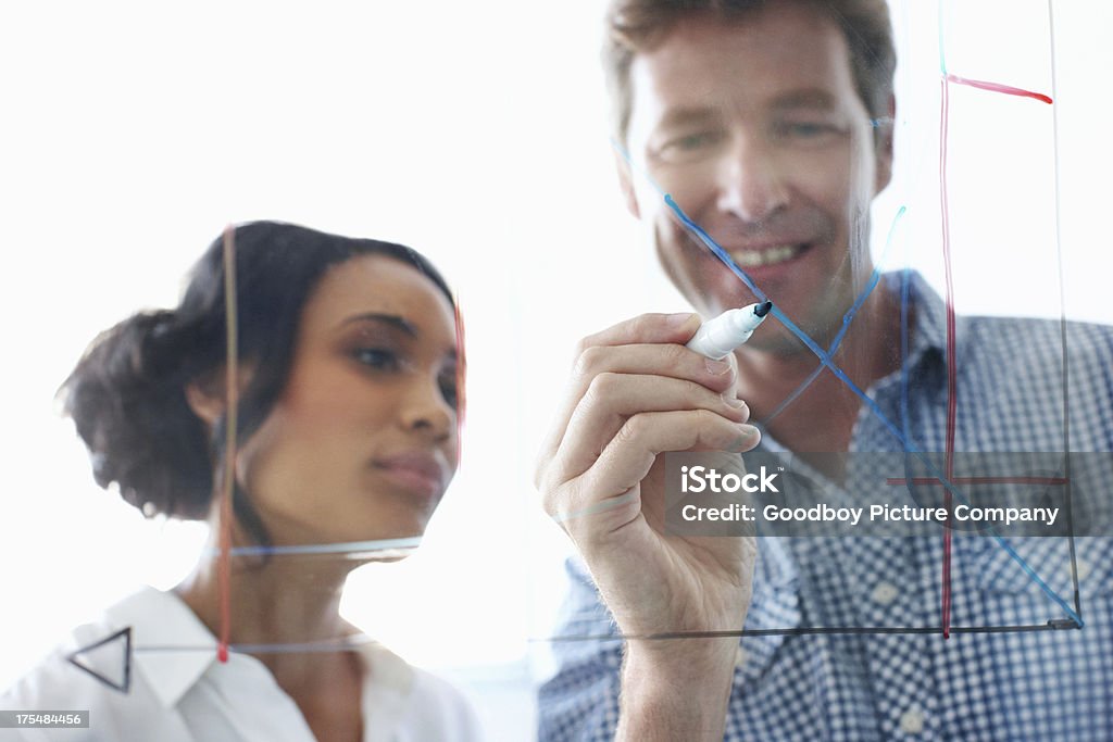 Proud of their superior planning Inspired businessman working along with a young coworker during a brainstorming session Drawing - Activity Stock Photo