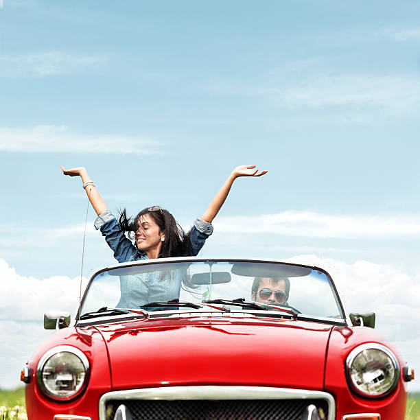 Happy young people in a cabriolet Happy young people in a cabriolet convertible stock pictures, royalty-free photos & images