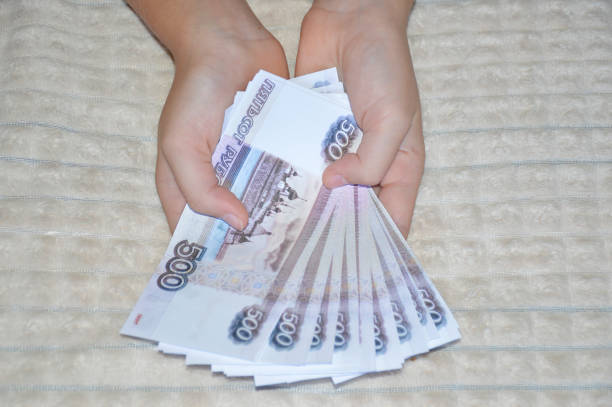 istock Russian rubles in female hands. payment for purchases 1754849323