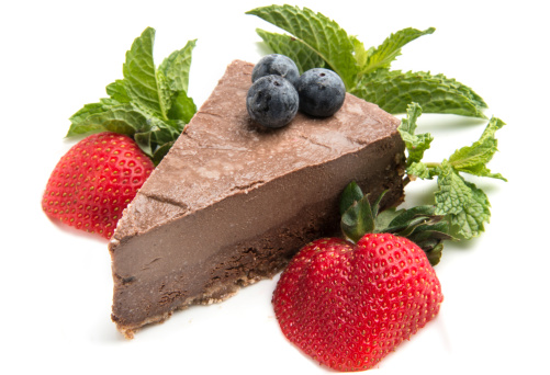 Chocolate Mousse Cake with strawberries and mint on white background