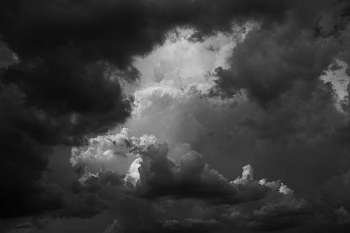 Black white dark gray dramatic night sky. Gloomy ominous storm rain clouds background. Cloudy thunderstorm hurricane wind lightning. Epic fantasy mystic. Or creepy spooky nightmare horror concept.