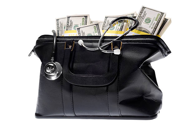 Doctor's Bag Doctor's Bag with stethoscope and money inside on a white background leather medical bag stock pictures, royalty-free photos & images