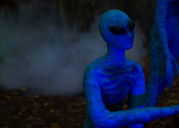 istock Halloween decoration, bright blue aliens on dark night background 1754861211