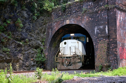 A locomotive emerges from the Catoctin Tunnel alongside the C&O Canal National Park. Looks pretty powerful to me as it comes out into the sunshine.