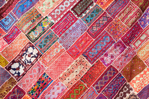 Wide image of carpet on display for sale at a souk